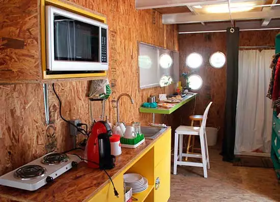 The main living area includes room for a kitchen, dressing room, closet, bathroom, shower, and work desk