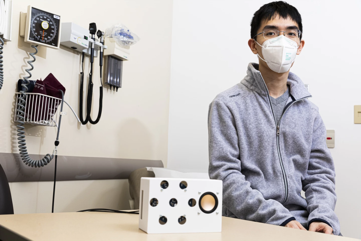 Lead author Anran Wang with the smart speaker developed at the University of Washington