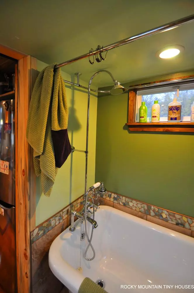 The Red Mountain 34' Tiny House's bathroom includes a full-size bath