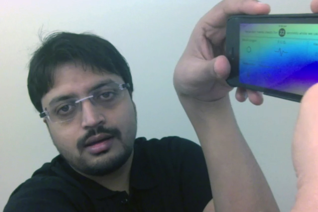 Hamish Patel demonstrates the Wello health monitoring iPhone case