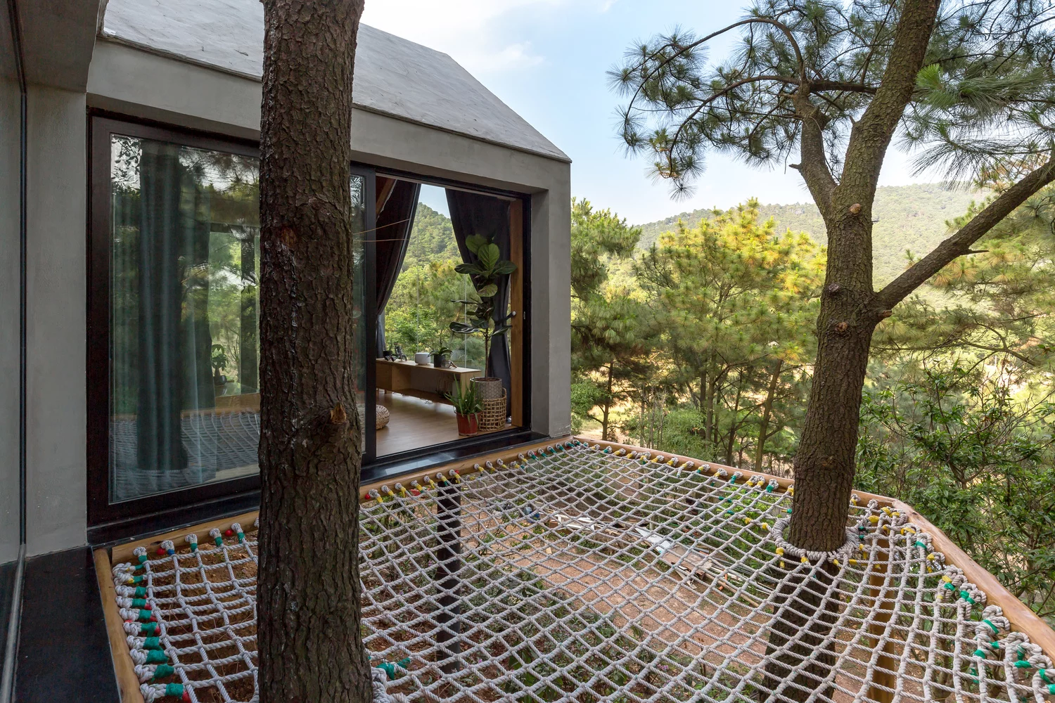 Forest House 02 is surrounded by vast forest landscape in the Sóc Sơn District, 30.6 km (19 mi) outside of Hanoi, Vietnam
