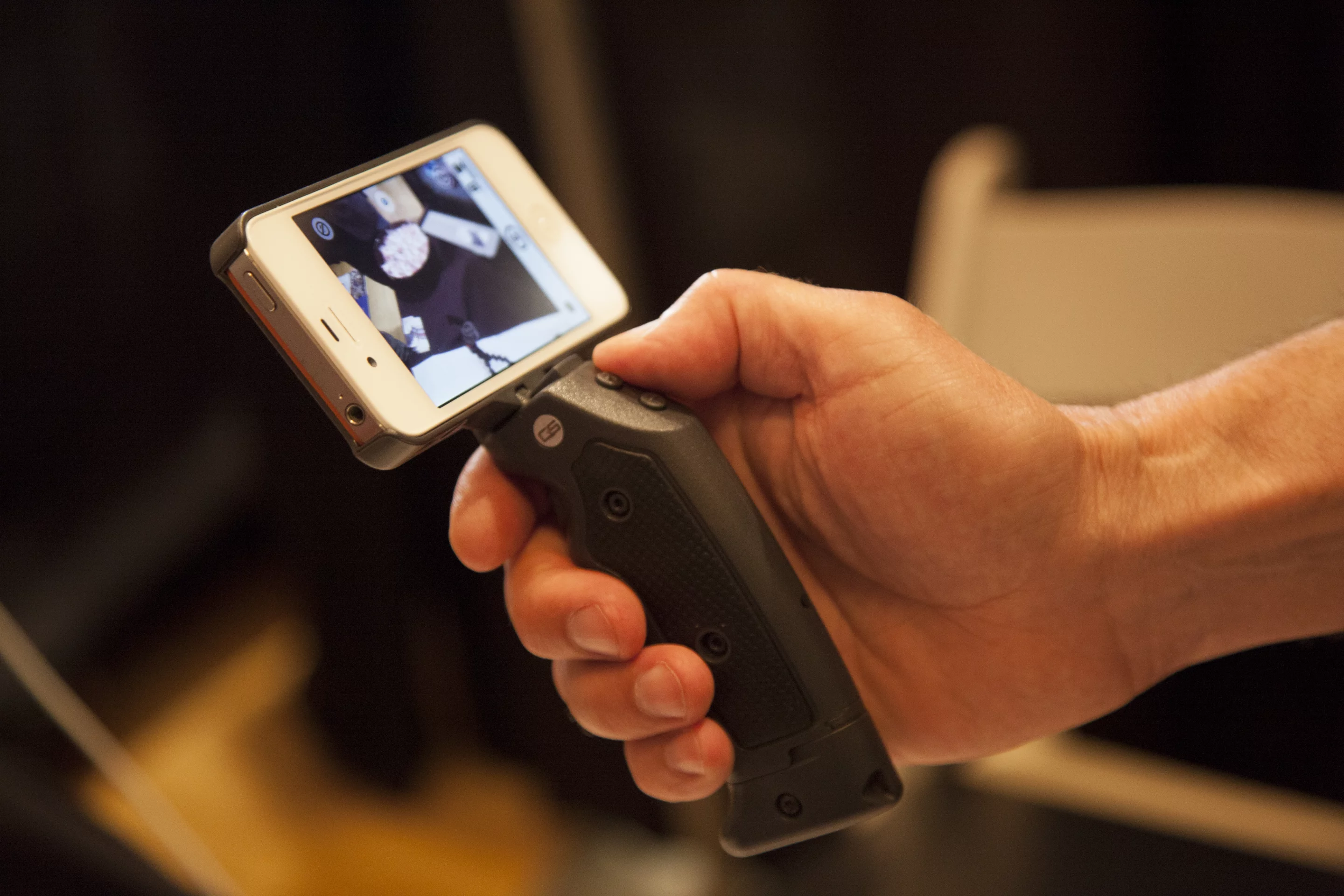 The Grip & Shoot system attaches an ergonomic pistol grip to an iPhone and connects via Bluetooth, providing greater control when taking photos and shooting video