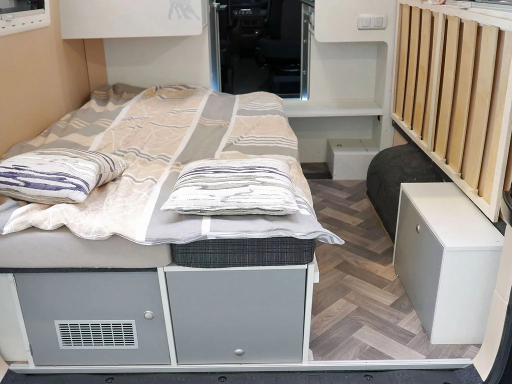 The single-bed duo floor plan on the Schwabenmobil includes the option of a hinged bed that creates bicycle storage
