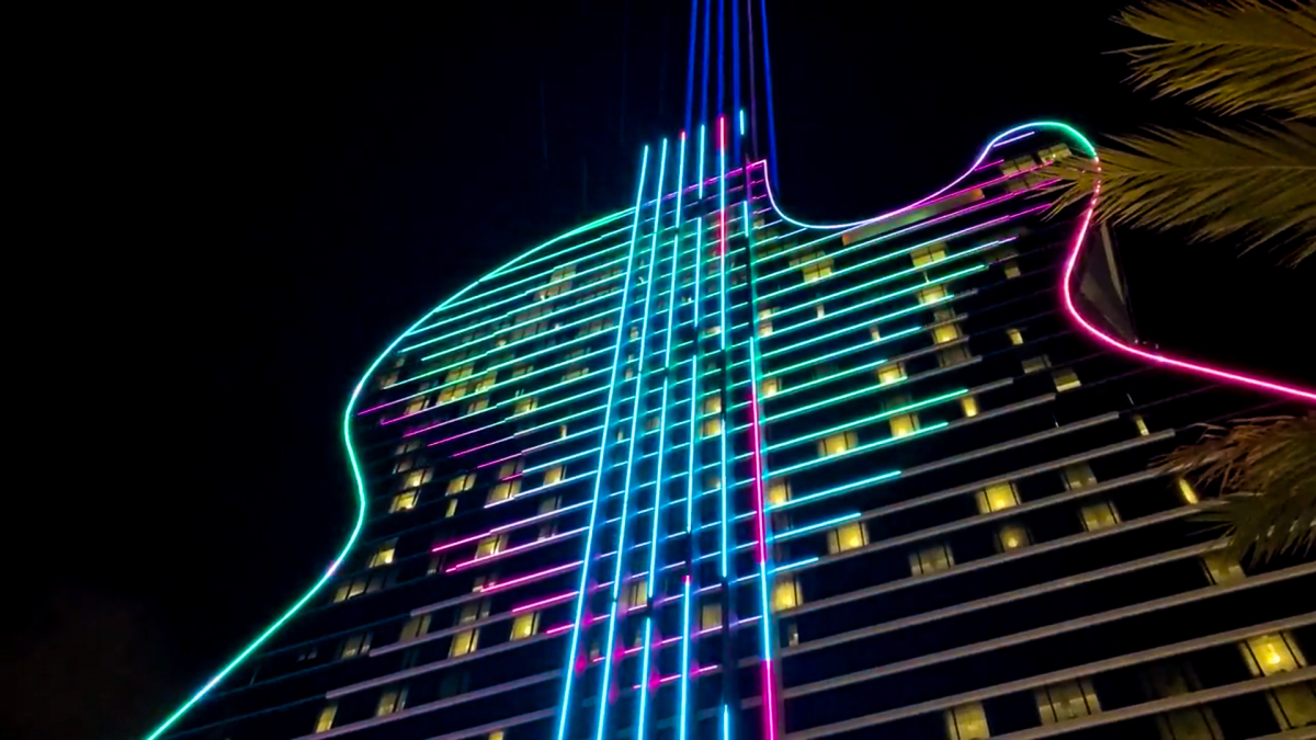 The 34-story Guitar Hotel towers 450 ft (137 m) into the South Florida skyline, taking on the familiar form of the instrument, complete with six strings running down the middle