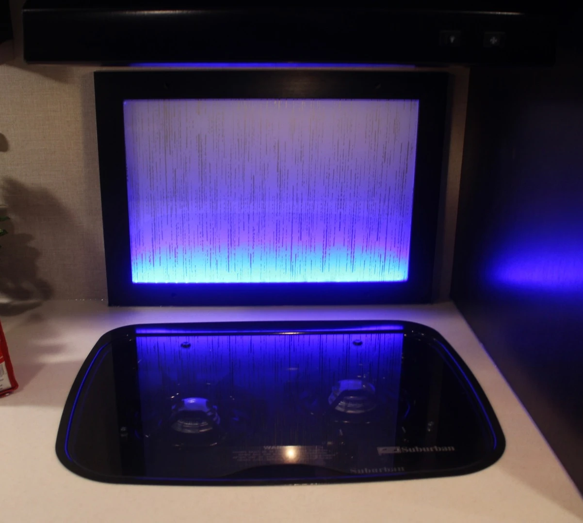 Plenty of ambient lighting throughout, including behind the stove