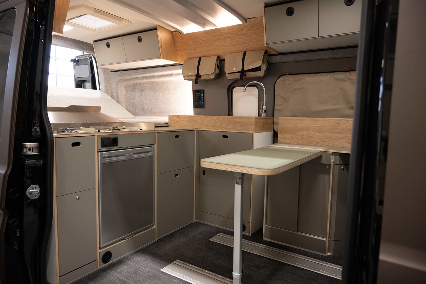 The Rocket Mountain interior includes a tilt-up rear bed, L-shaped kitchen, removable dining table and swivel front seats; rear seats are available optionally