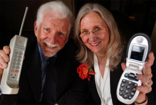 Martin Cooper and his wife and business partner Arlene Harris with their respective cell phone inventions (Photo: Business Wire)