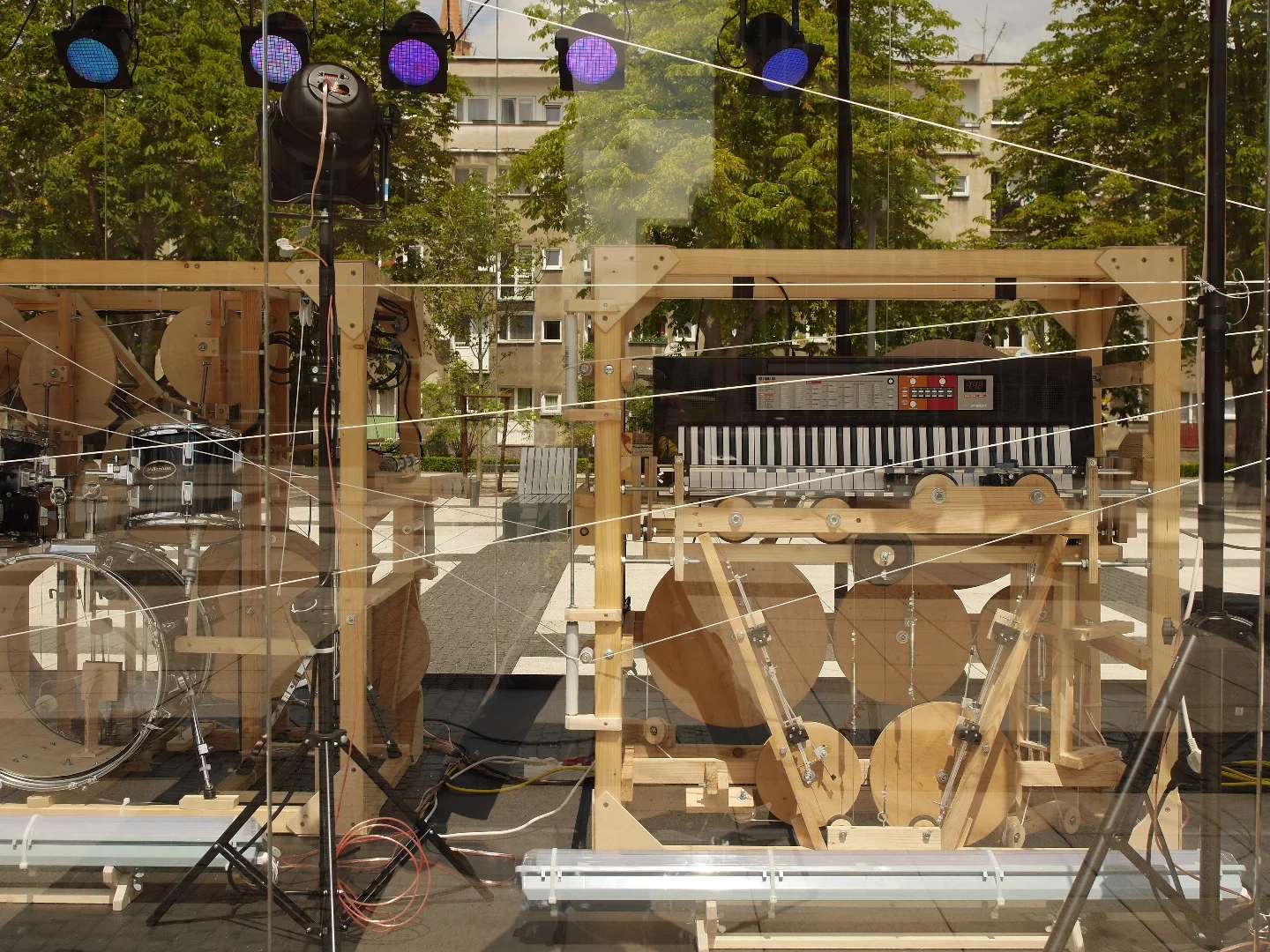 A seemingly endless web of thin ropes activate pulleys, springs, weights and levers