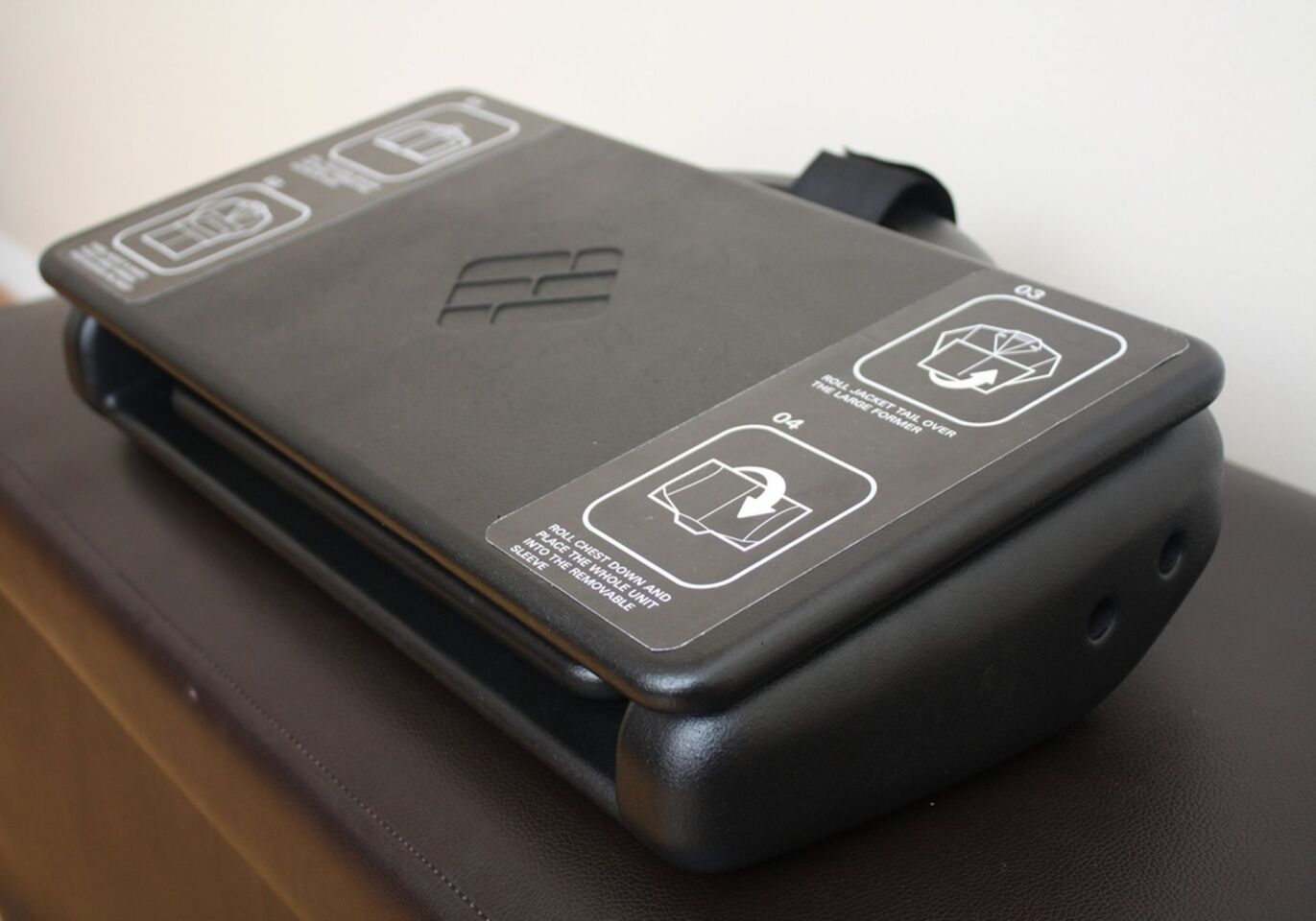 The Freefold system comprises a main foam suit former, a small flat panel for folding trousers around and a larger chest panel