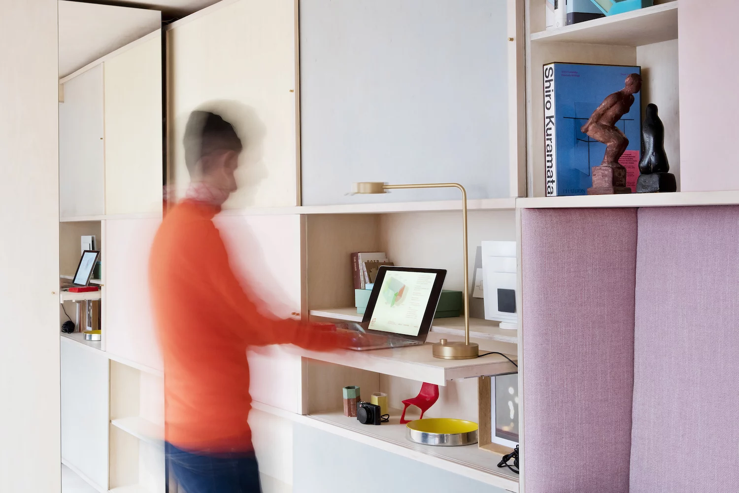 The 13 sq Metre House features a neat storage shelf with extending standing desk