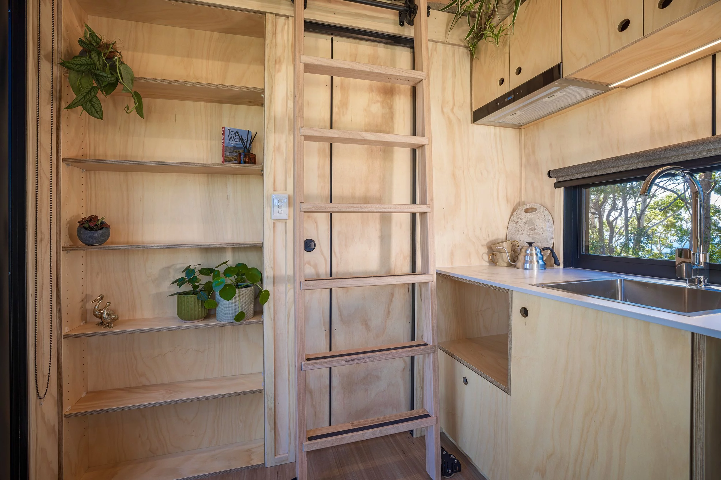 The Five Four's ladder slides to provide access to the upstairs bedroom and the storage space