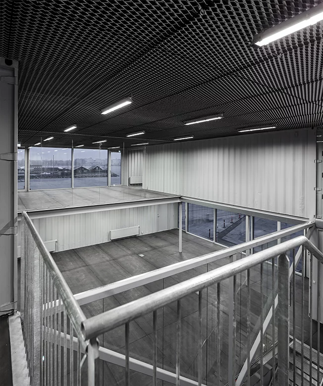 Arcgency designed a building around shipping containers that could be disassembled with relative ease