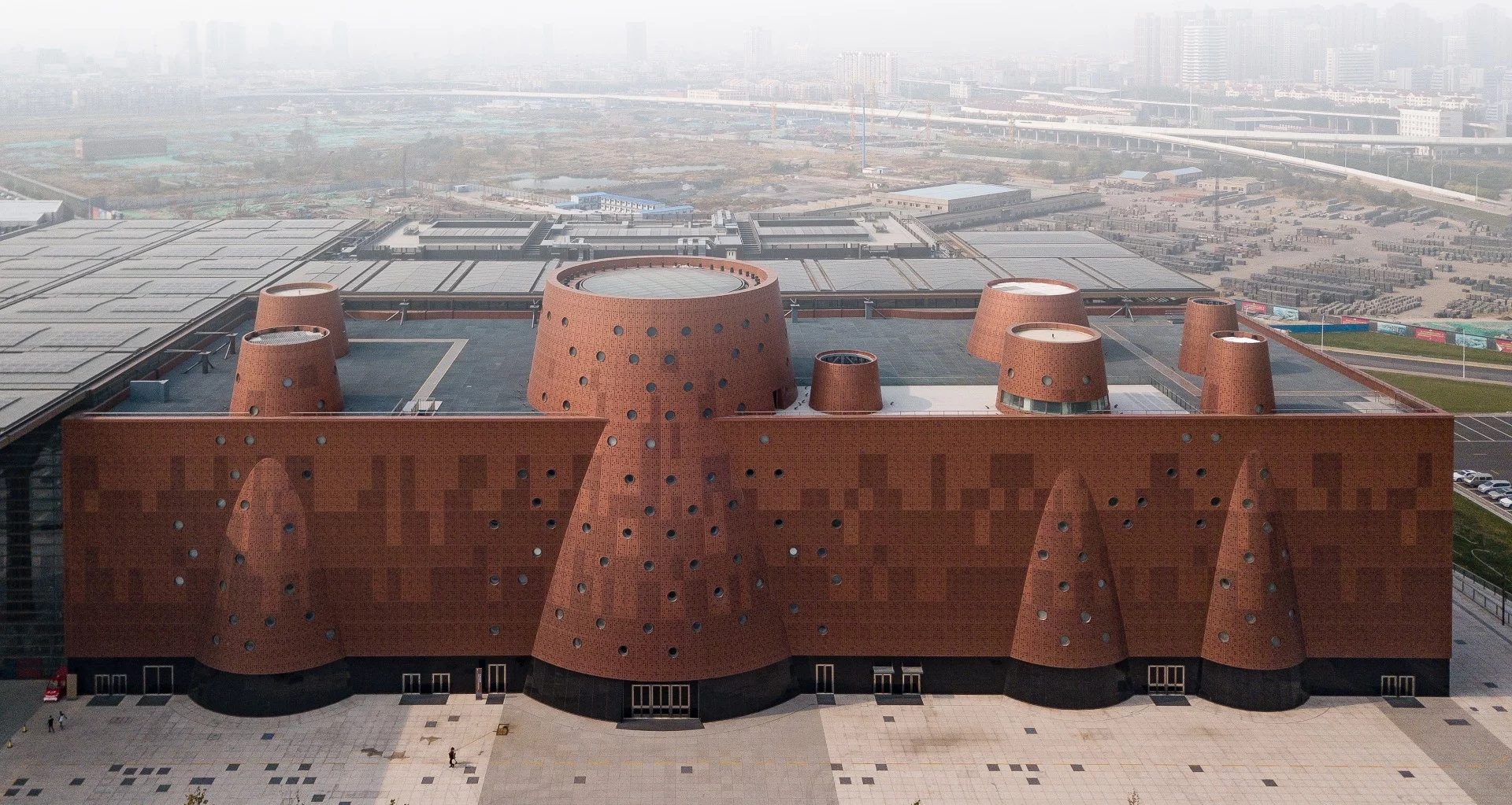 The Exploratorium measures 33,000 sq m (355,200 sq ft) and is finished in an eye-catching reddish aluminum facade