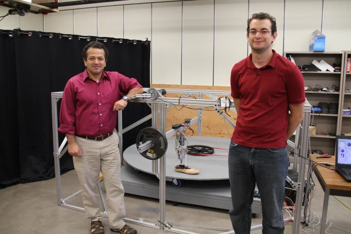 Prof. Mo Rastgaar (left) and PhD student Evandro Ficanha, with the leg and its testing rig