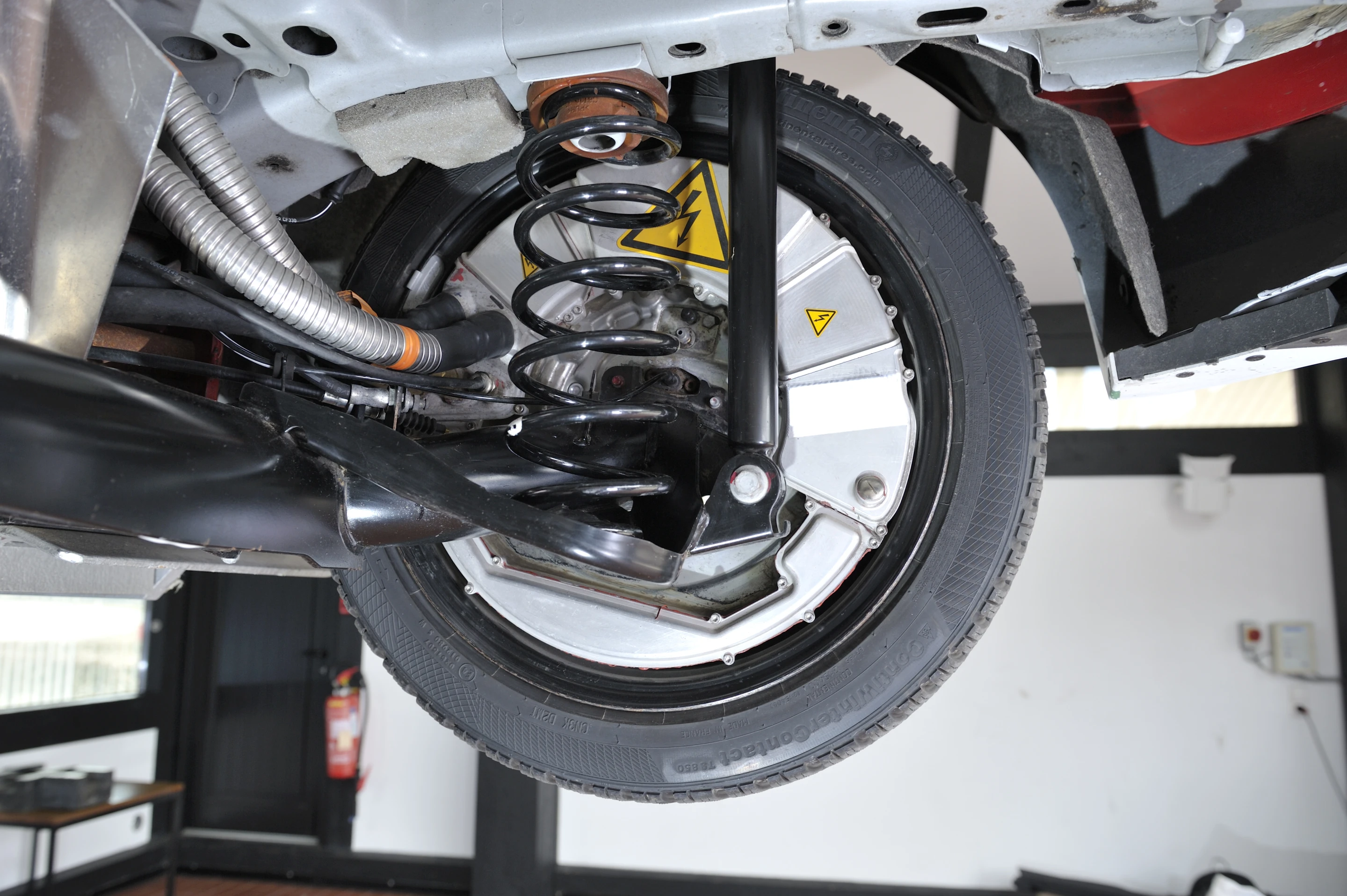 Warning stickers mark the electric hub motors in the rear wheels