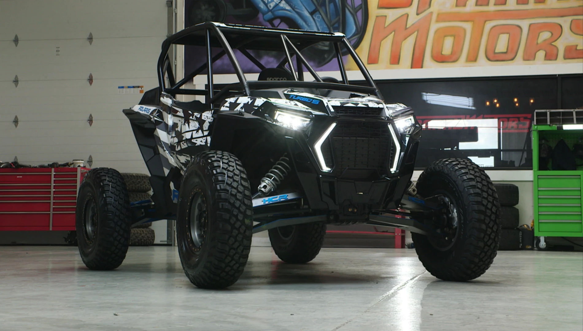 The car has a beefed-up roll cage, suspension struts, race seat...