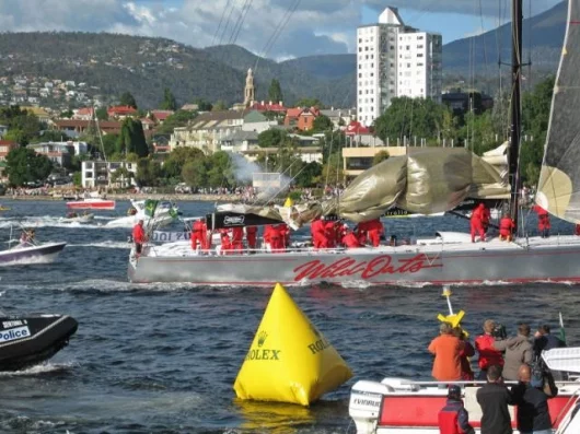 WILD OATS XI crossing the finish line and breaking the Rolex Sydney Hobart Yacht Race record Photo: Daniel Forster