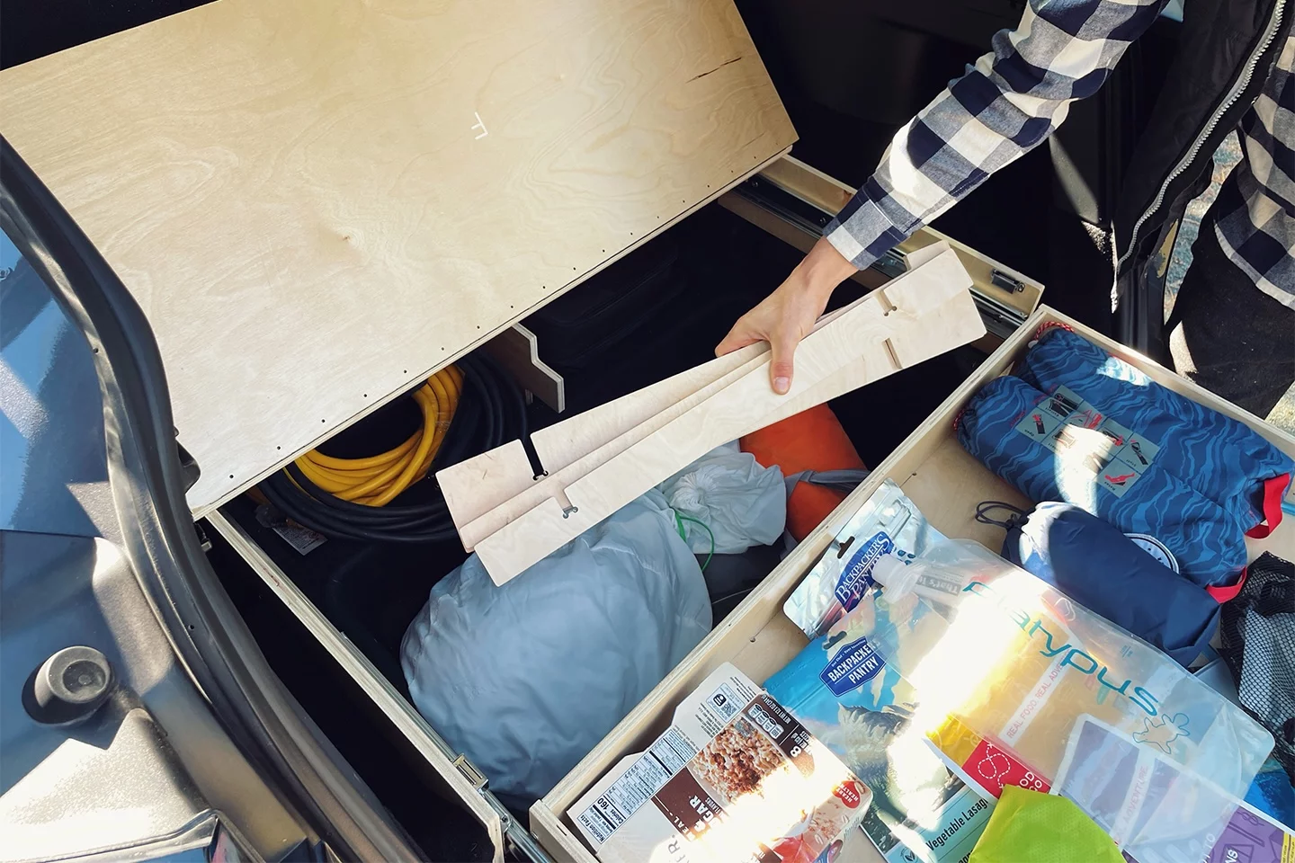 Pulling the drawer out provides access to the vehicle's sub-trunk, where a lot more gear (including the pieces of the sleeping platform) can be stored