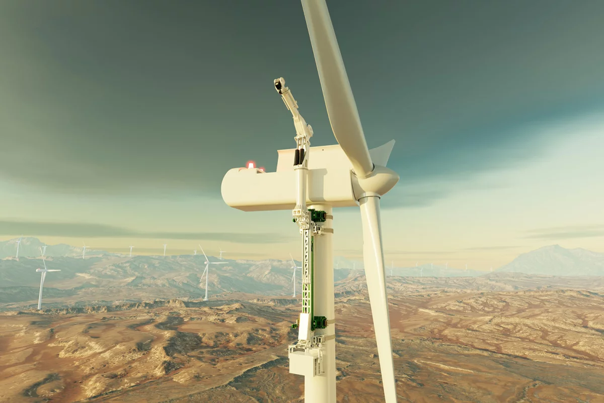 The KoalaLifter hugs a turbine tower, a little like a koala in a Eucalyptus tree, then climbs up and deploys a powerful crane