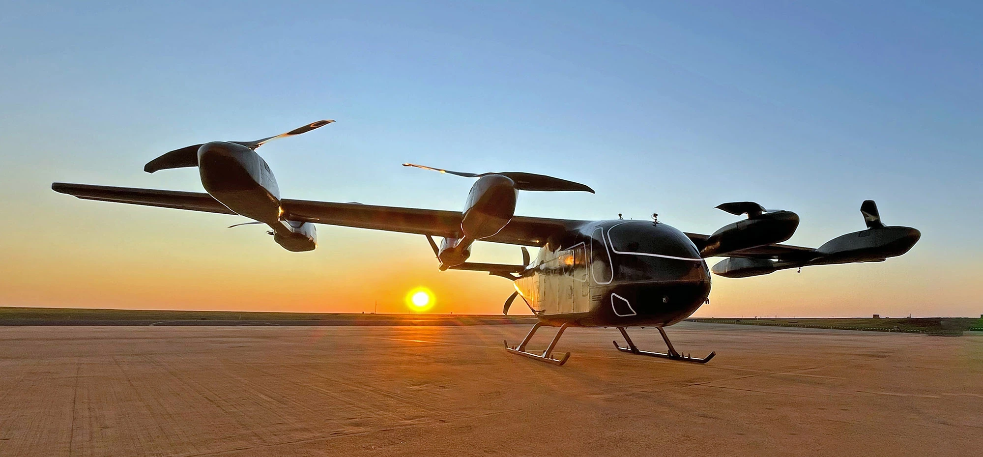 The prototype Eve Air Mobility sits magestically against the setting sun backdrop