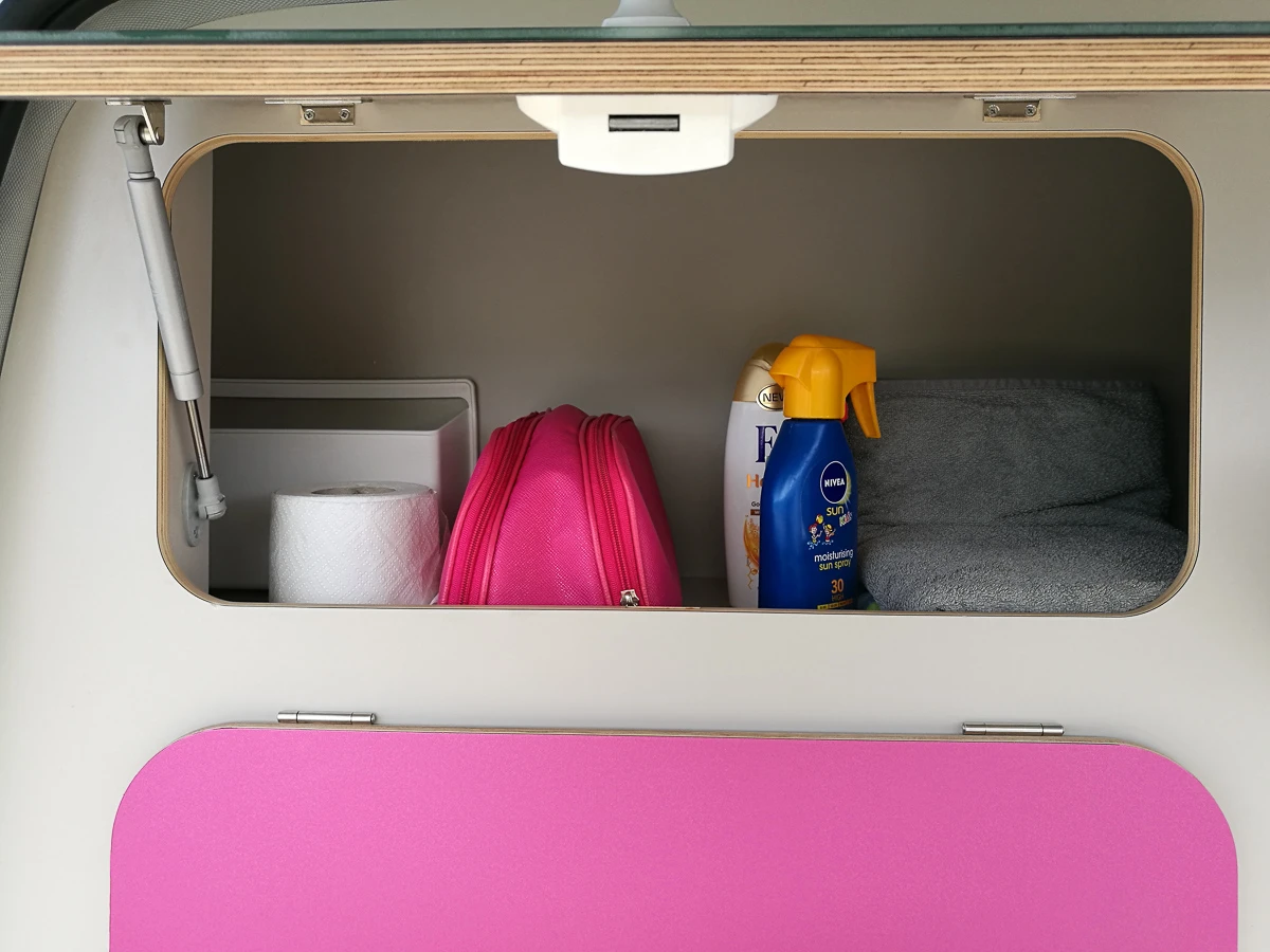 The divider wall inside is a storage cabinet/kitchen outside