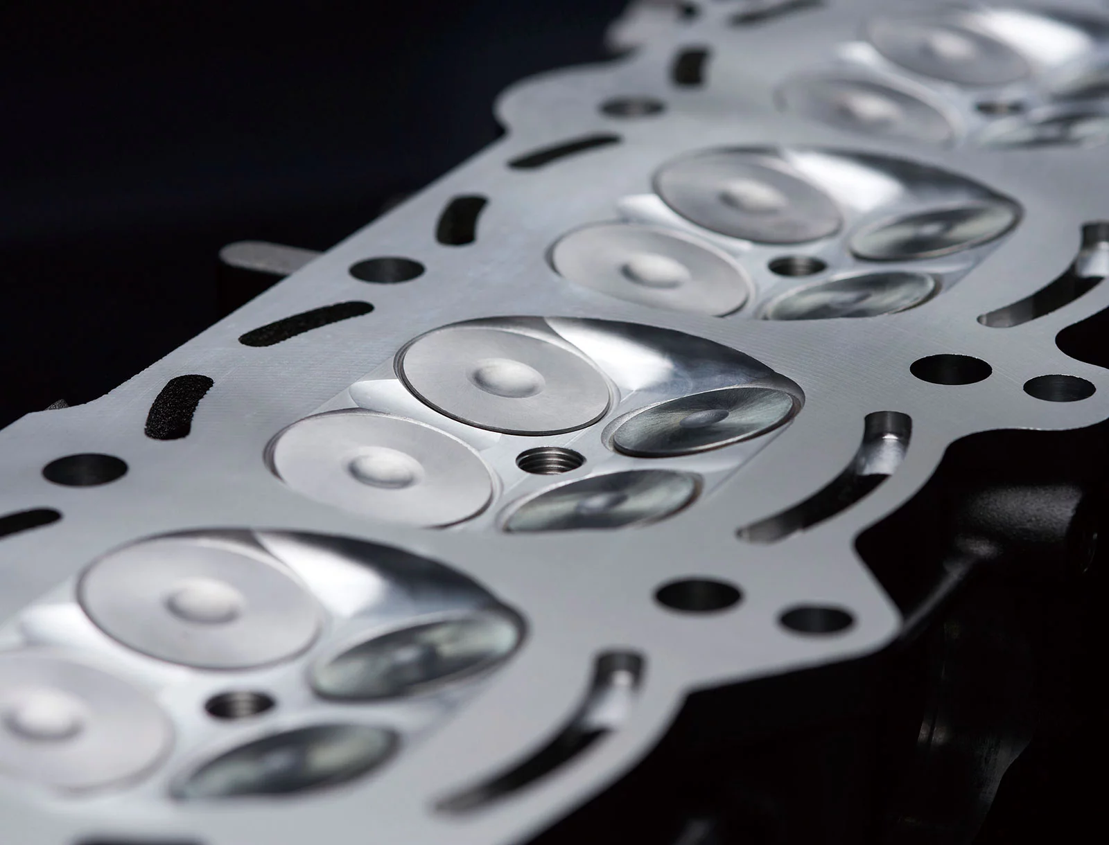 Combustion chamber design eliminates the squish area. Small engines use the squish to generate turbulence that helps promote more thorough fuel-air mixing. However, for a large high-output engine, preventing engine knock was a more important factor: best performance was obtained with a controlled combustion. The combustion chamber is formed by machining; precise control of the chamber volume also helps prevent engine knock.Compared to a naturally aspirated liter-bike, the compression ratio is relatively low at 8.5:1—but ideal when combined with the high-pressure air used in the supercharged engine.