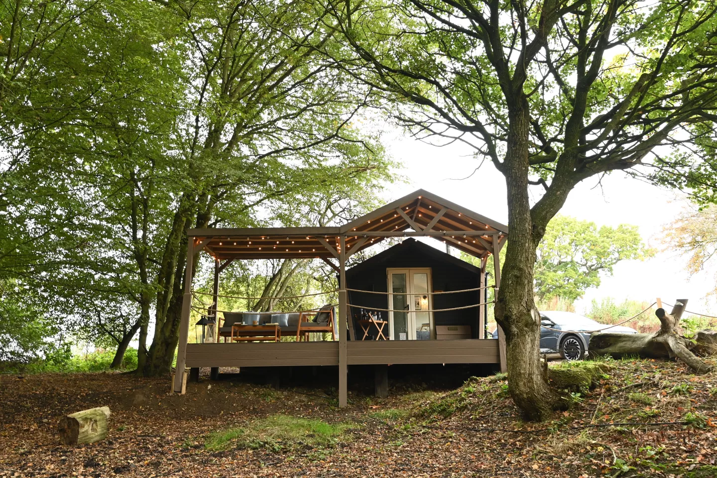 The cabin can accommodate two guests, boasts an open-plan living space, single bedroom with double bed and ensuite bathroom, and outdoor decking with firebowl and BBQ