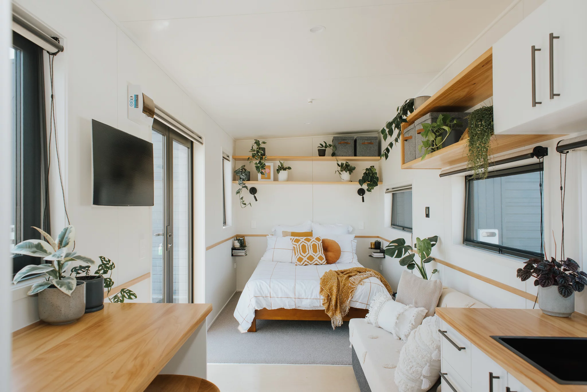 The Tadpole Tiny House features one open living area that includes the living room and bedroom