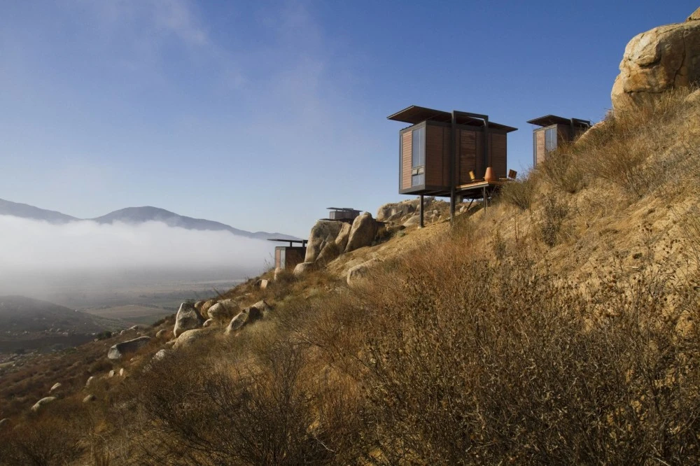 The 20-square-meter cabins are mounted on steel stilts, and their small size is overtaken by the vast panoramic vistas of the dramatic surrounding landscape