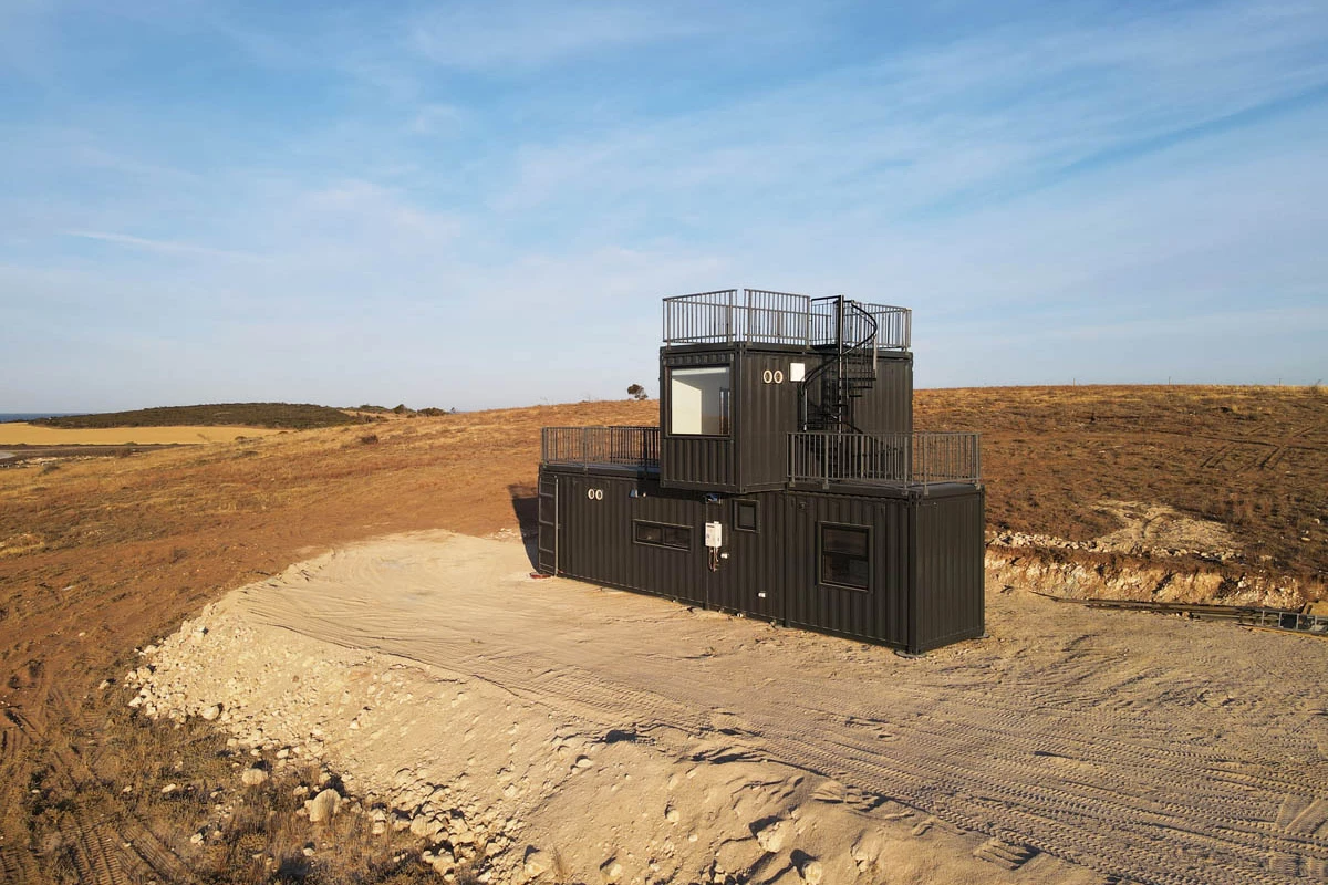 The Mark T is a surprisingly spacious two-story tiny house that's built from three shipping containers