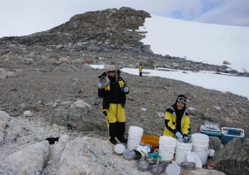 Researchers Belinda Ferrari and Eden Zhang collecting samples in Antarctica