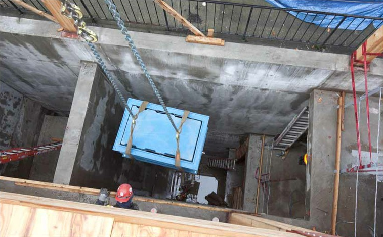 A composter is lowered into the basement, March 2012