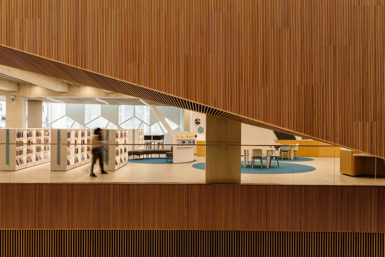 "Wood slats line the perimeter of the open atrium, shaped in plan like a pointed ellipse, serving as an orientation device for people to quickly grasp the circulation and organizational logic of the library," says Snøhetta