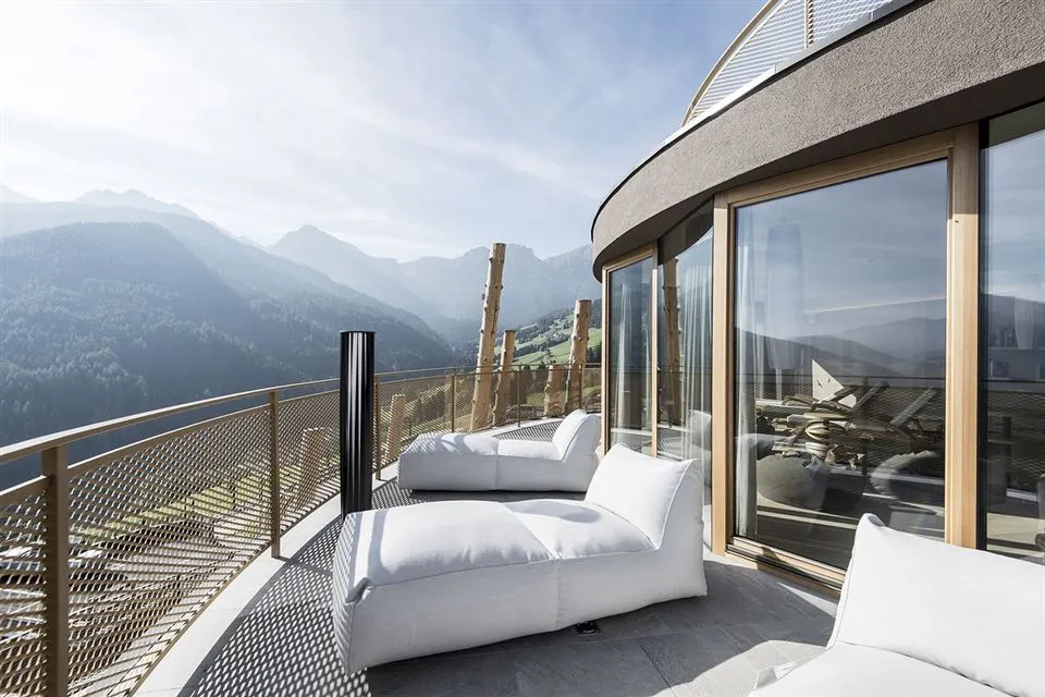 The Hubertus Hotel and pool overlooks the stunning Dolomite mountain range, a UNESCO World Heritage Site