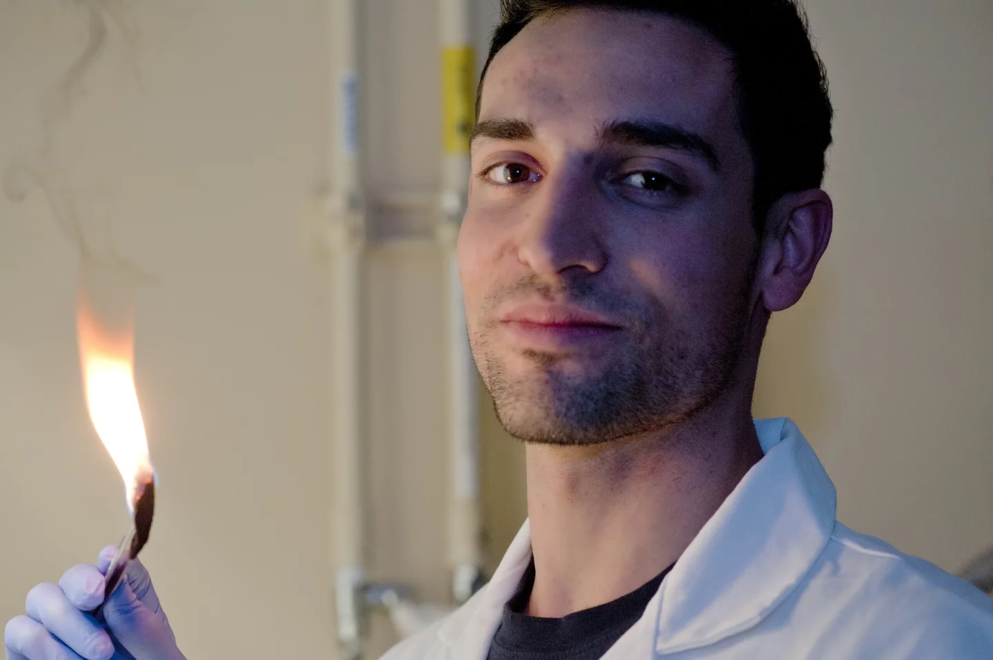 Rice University graduate student Daniel Hashim burns oil out of a sponge-like material so it can be reused (Photo: Jeff Fitlow/Rice University)