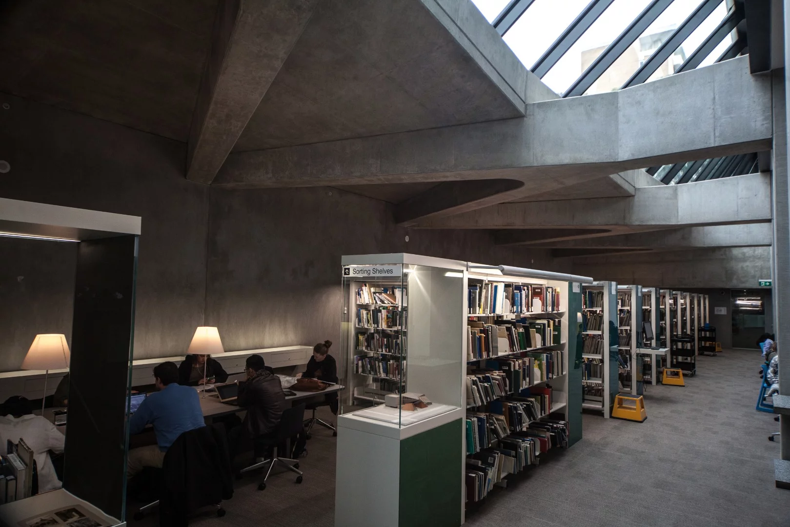 On one side of the groundfloor thoroughfare is a library complete with study nooks, shared workspaces and an underground bookstack