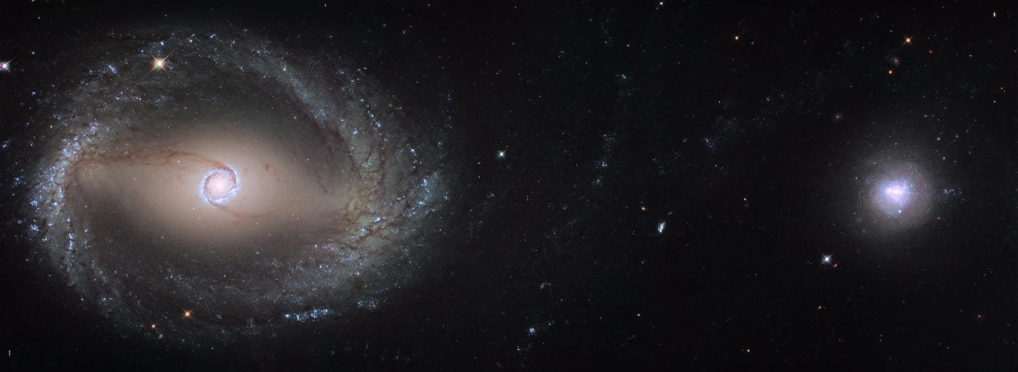 Composite Hubble image of the barred spiral galaxy NGC 1512 (left) and the dwarf galaxy NGC 1510 (right). Both galaxies are located roughly 30 million light-years away in the constellation of Horologium