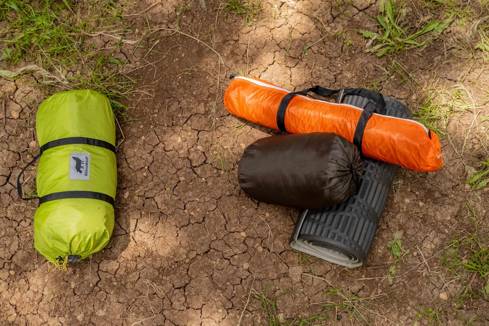 On the left is the all-in-one RhinoWolf, packing a tent, sleeping bag and air mattress into a small, light unit