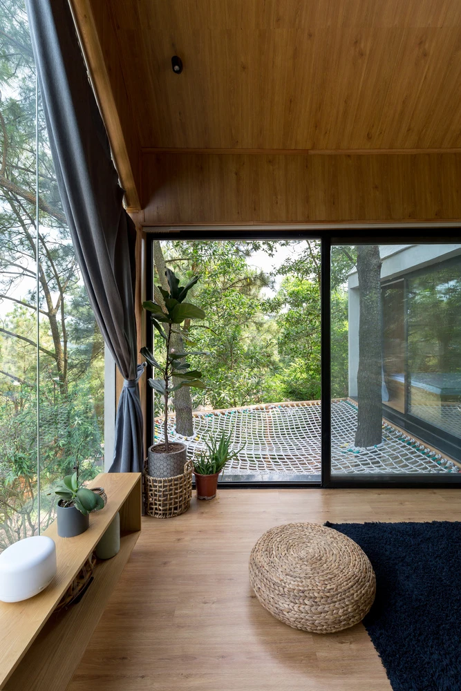 Inspired by treehouses, the home features a fun exterior net terrace that takes advantage of the height of the front of the home