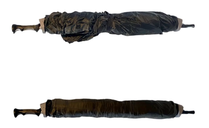 The tent fabric is rolled around the pole and secured by a Velcro strap (top) and then covered with an included sleeve (bottom)