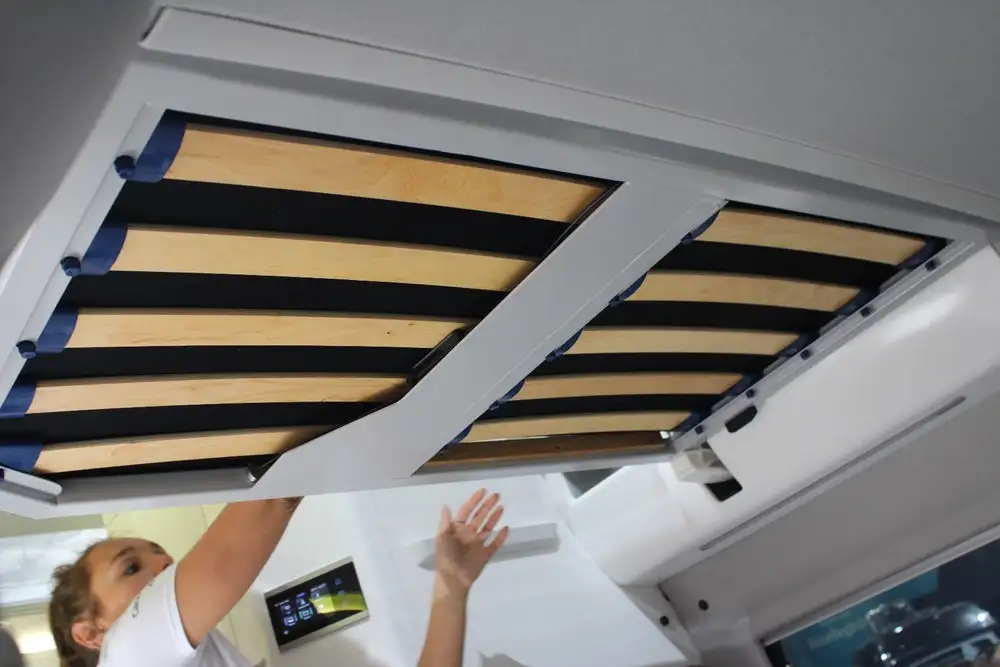 The available kids bed on the Grand California 600 slides out from the above-cab alcove