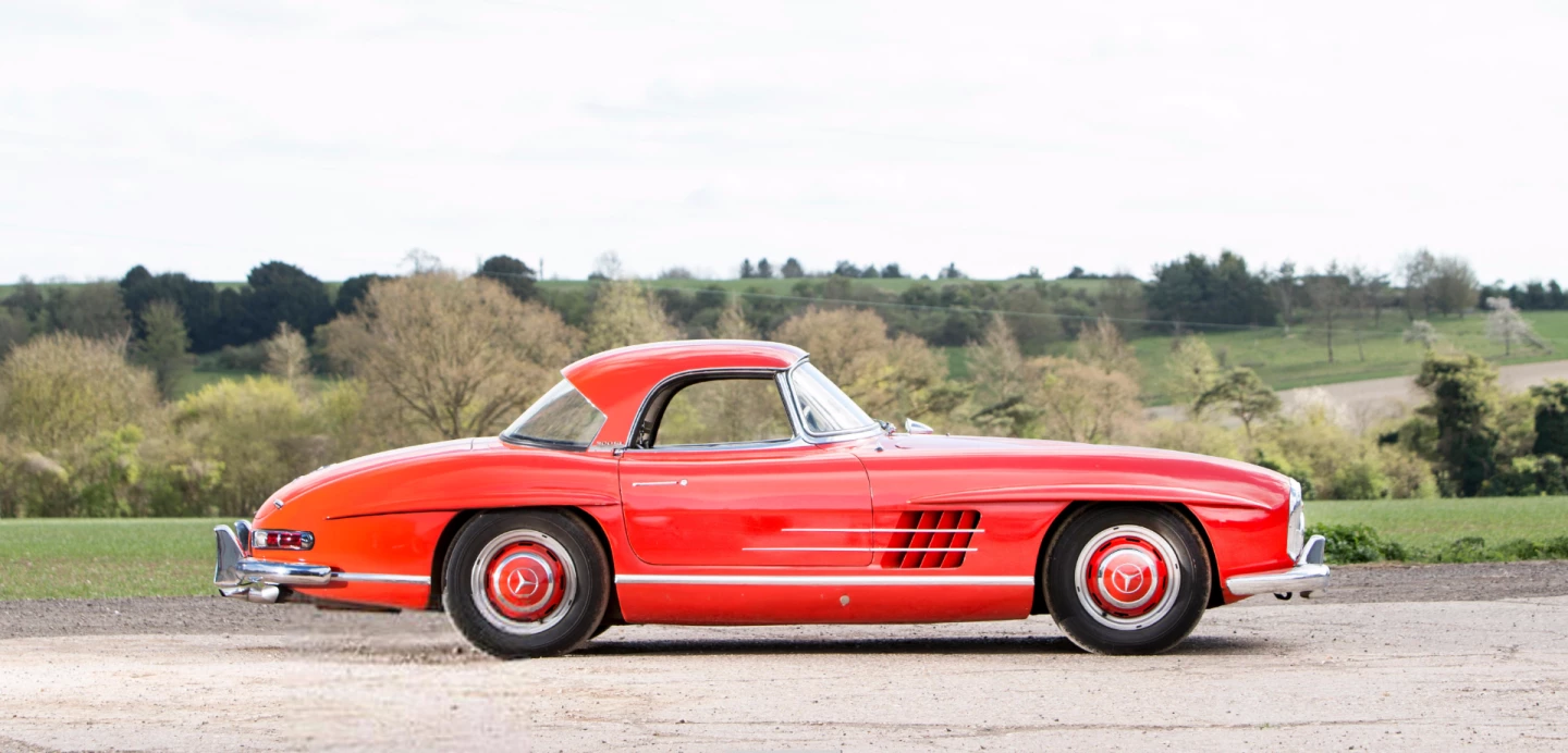 Sold new into the United States, this red 1962 Mercedes-Benz 300 SL Roadster was sold complete with factory hardtop and two original sales brochures to narrowly miss being the top lot of the sale. Auction description