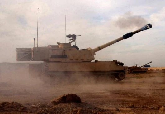 Soldiers fire a M109A6 Paladin howitzer near the Abu Ghraib, Baghdad, Iraq. The Soldiers are assigned to Battery C, 4th Battalion, 1st Field Artillery Regiment.