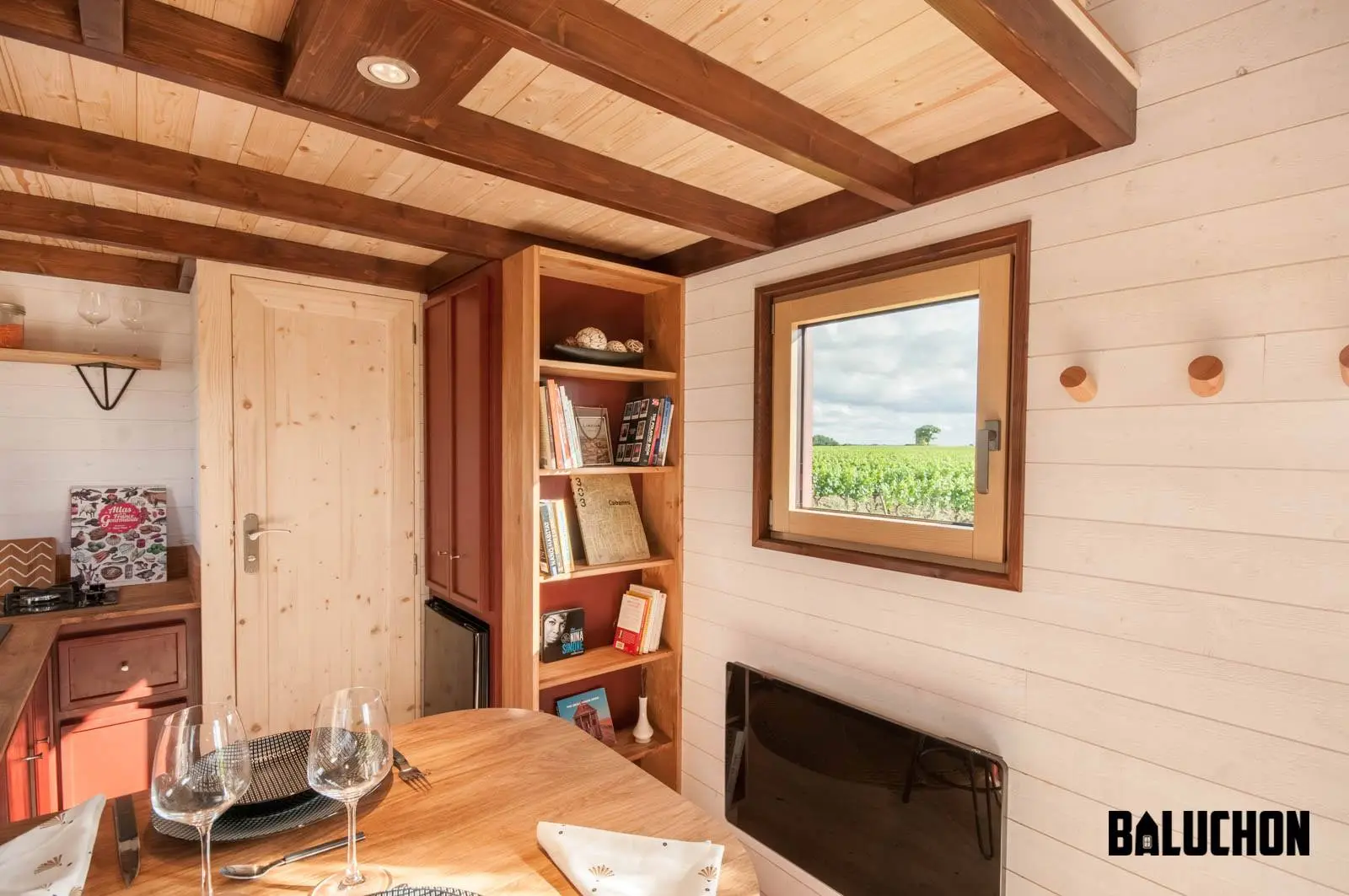 The Pampille's kitchen/dining area also has a bookcase shoehorned in