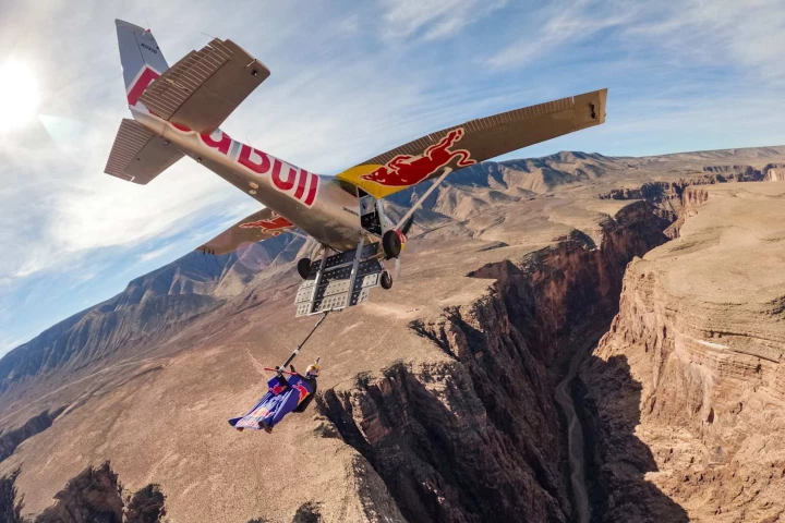 Skydiver Max Manow soars above Hell Hole Bend, after grabbing on to a handlebar attached to Luke Aikins' plane