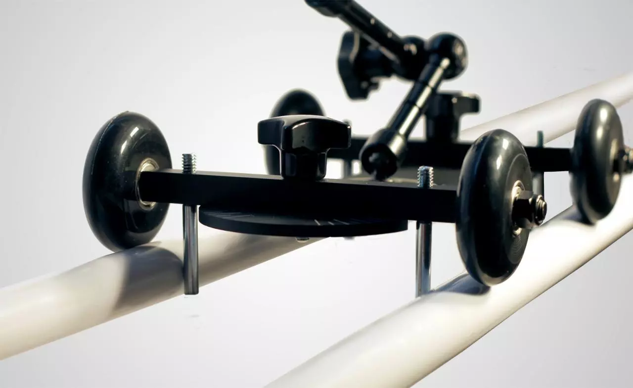 The rail kit provides two blocks with clamps and four guide rods that fit onto the bottom of the dolly to keep it steady