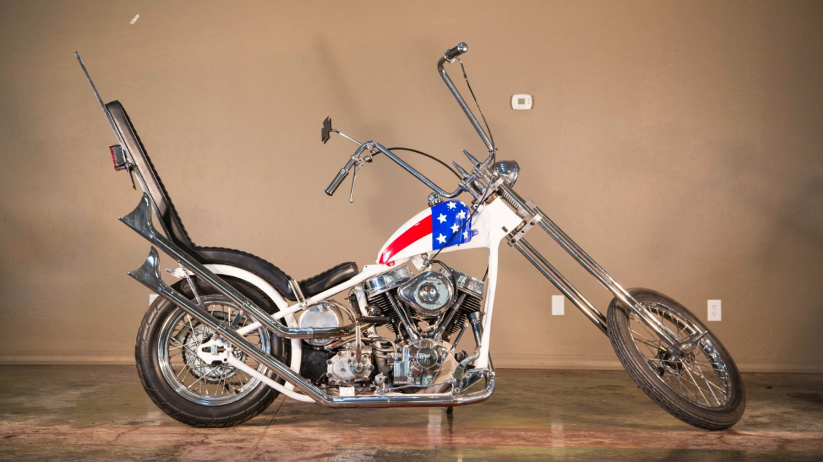 Unless you've been living in a box for the last 50 years, you'll recognize a Captain America Chopper from the 1969 feature film Easyriders. The original, or maybe it wasn't, reportedly sold for $1,620,000, then it didn't, and then maybe it did. We don't know for sure what happened and that's why we report on auction results where the real price can be verified. This replica does the job nearly as well as the original, and cost a lot less than the price the original sold for (or maybe it didn't). At $19,250, which is what this bike sold for, you'll have saved $1.6 million for the journey.