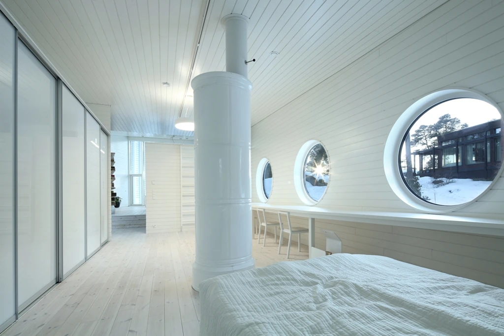 The master bedroom includes three large porthole-like windows