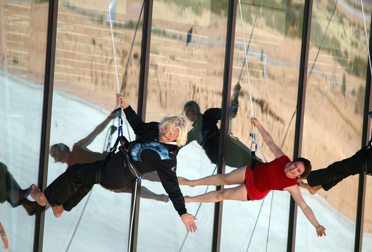 Sir Richard Branson rappels down his new Virgin Galactic terminal facility at Spaceport America during dedication ceremonies (Credit: Mark Greenberg)