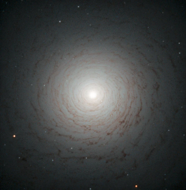 This striking cosmic whirl is the centre of galaxy NGC 524, as seen with the NASA/ESA Hubble Space Telescope. This galaxy is located in the constellation of Pisces, some 90 million light-years from Earth